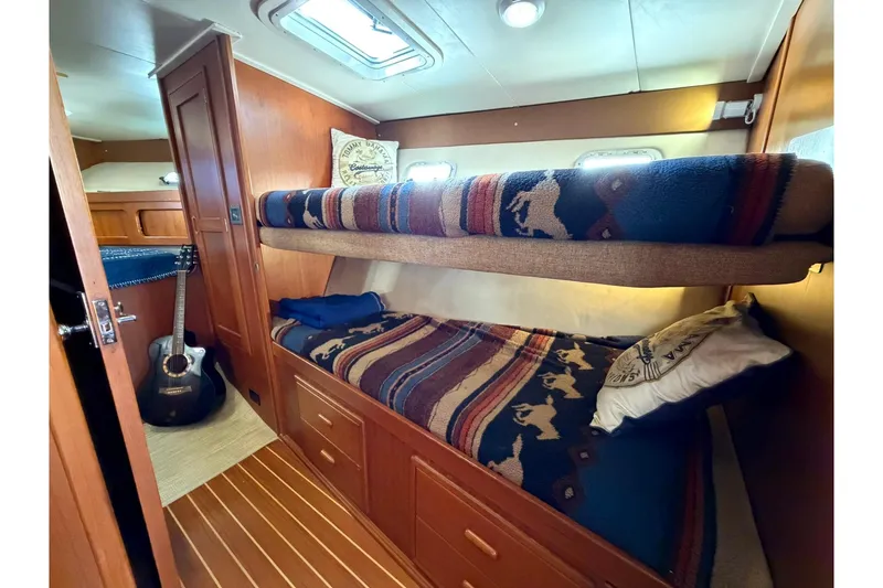 Slide: The Image of Cozy cabin with bunk beds in 1993 Riviera 47 Open Flybridge yacht. - 22
