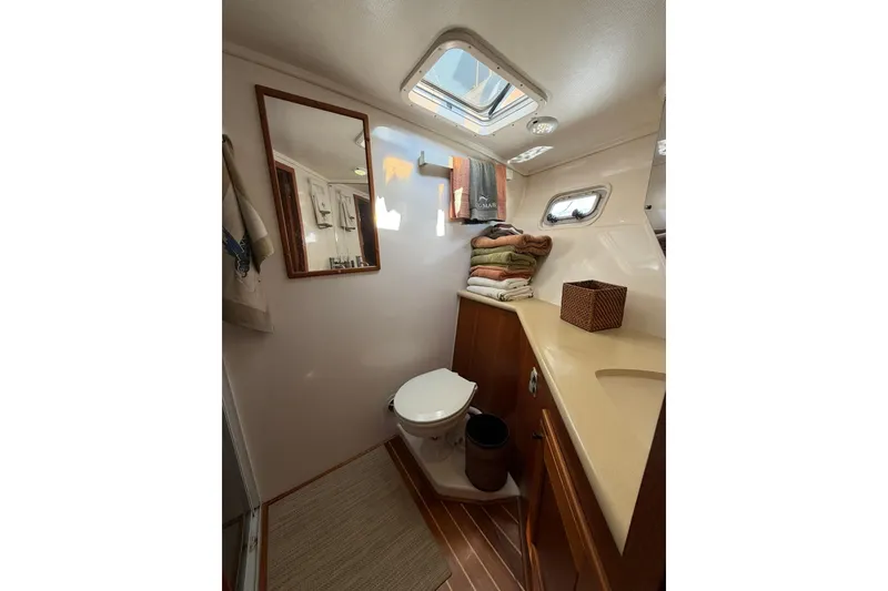 Slide: The Image of Cozy cabin interior of 1993 Riviera 47 Open Flybridge with bunk beds and guitar. - 23