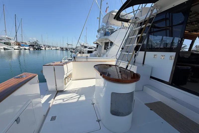 Slide: The Image of Bathroom interior of 1993 Riviera 47 Open Flybridge yacht, featuring toilet, mirror, and towels. - 25