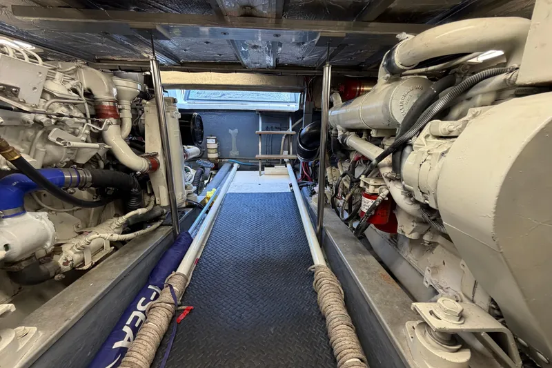Slide: The Image of A person in a small inflatable boat on clear blue water, waving and wearing a red cap. - 30