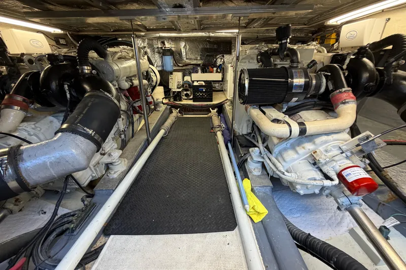 Slide: The Image of Engine room of a 1993 Riviera 47 Open Flybridge yacht, showcasing dual engines and equipment. - 31