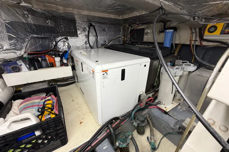 Slide: The Image of Engine room of 1993 Riviera 47 Open Flybridge, showcasing dual engines and mechanical components. - 32