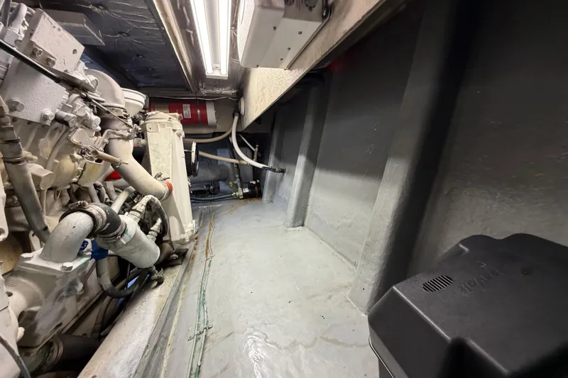 Slide: The Image of Engine room of 1993 Riviera 47 Open Flybridge with visible machinery and wiring. - 34