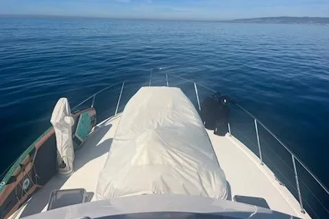 Slide: The Image of 1993 Riviera 47 Open Flybridge yacht on calm ocean waters. - 5