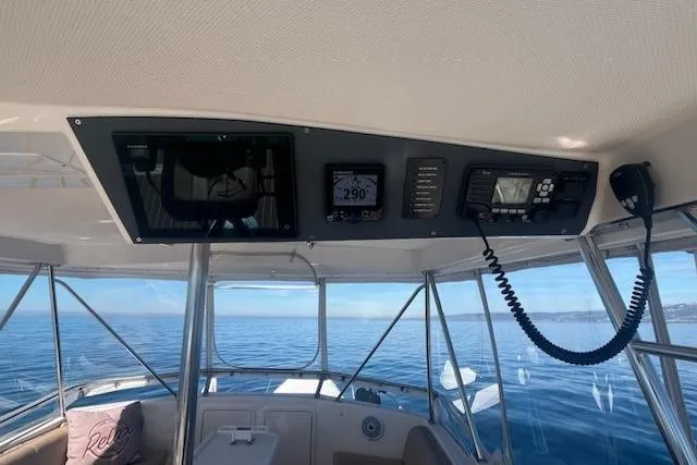 Slide: The Image of 1993 Riviera 47 Open Flybridge interior with navigation equipment and ocean view. - 6