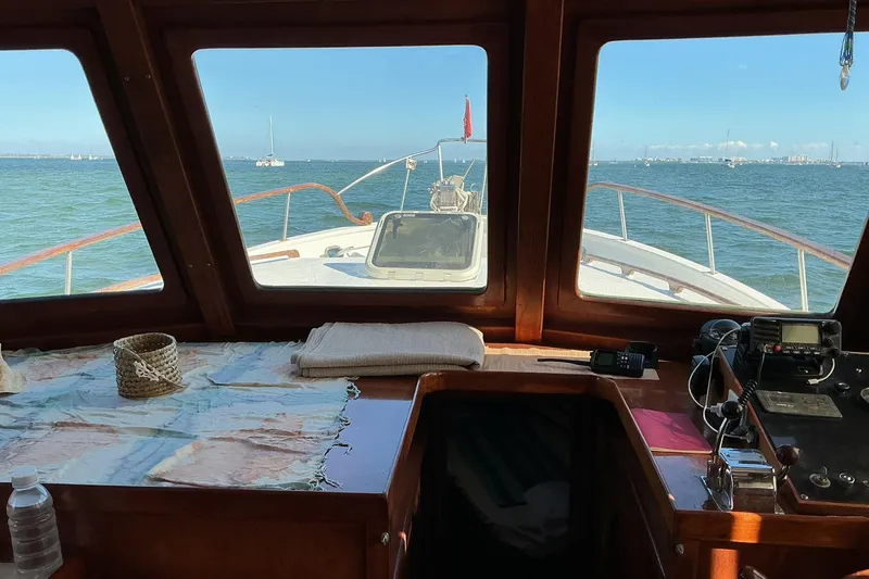 Slide: The Image of Interior view from 1977 Universal Marine Europa boat, overlooking ocean with navigation equipment. - 11