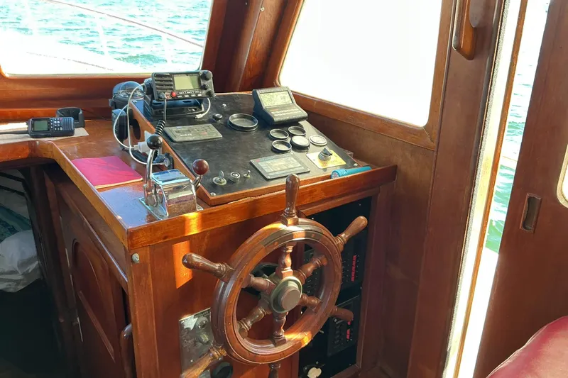 Slide: The Image of 1977 Universal Marine Europa boat helm with wooden wheel and navigation equipment. - 12