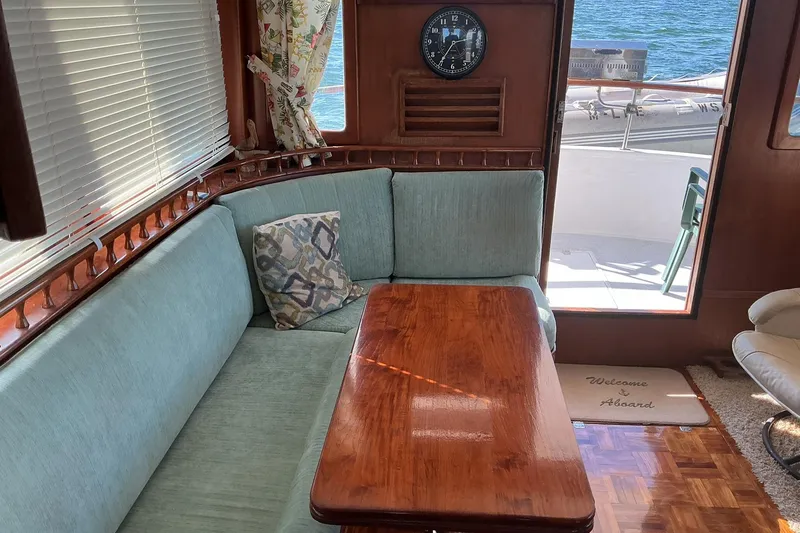 Slide: The Image of Cozy interior of 1977 Universal Marine Europa yacht with wooden table and sea view. - 13