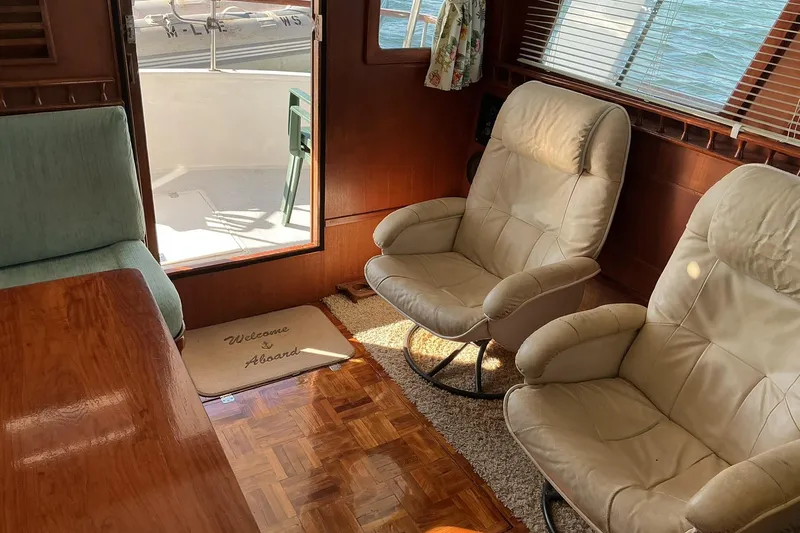 Slide: The Image of Interior of 1977 Universal Marine Europa yacht with cozy seating and welcome mat. - 14