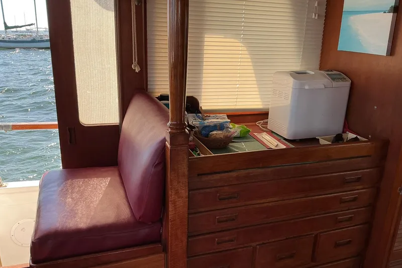 Slide: The Image of Interior of 1977 Universal Marine Europa boat with wooden cabinetry and seating. - 18
