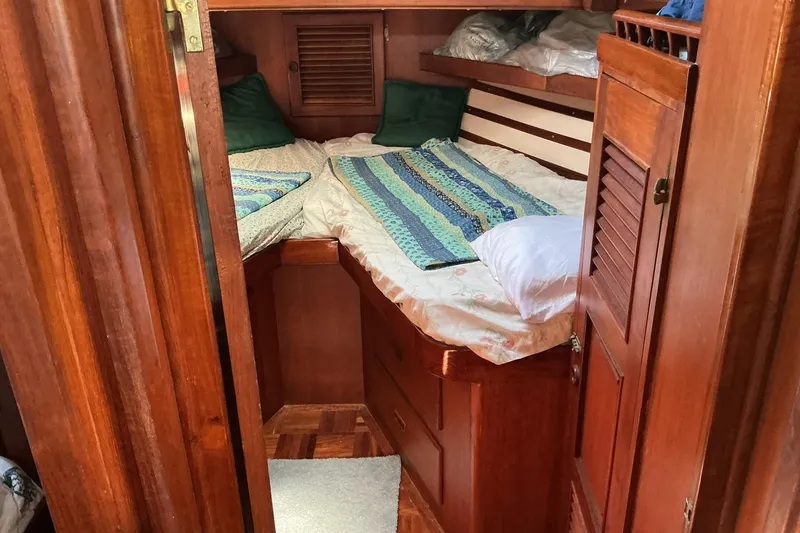 Slide: The Image of Cozy cabin interior of 1977 Universal Marine Europa with wooden furnishings and twin beds. - 19