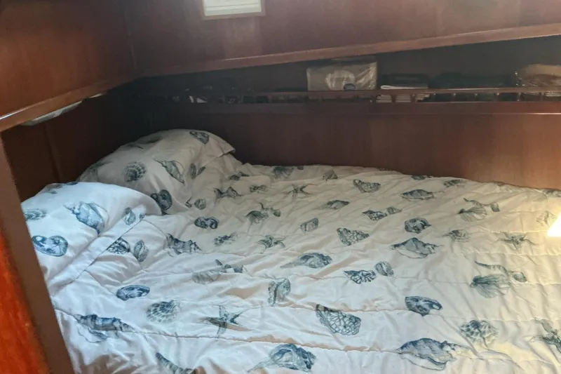 Slide: The Image of Cozy cabin bed with seashell-patterned bedding in 1977 Universal Marine Europa. - 22