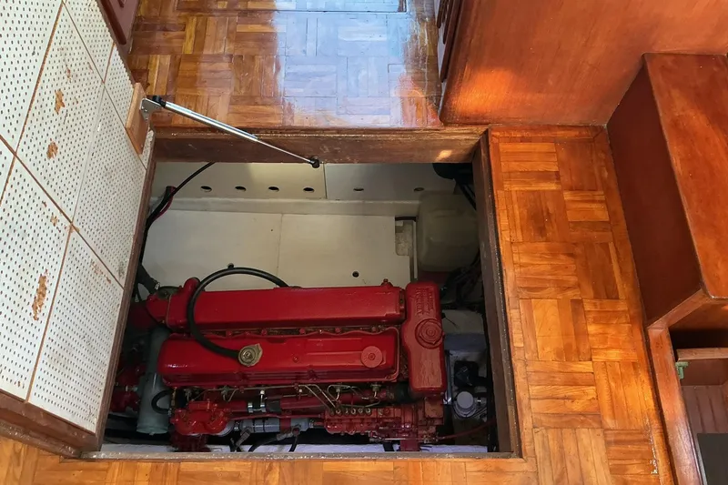 Slide: The Image of Engine compartment of a 1977 Universal Marine Europa boat with red engine. - 23