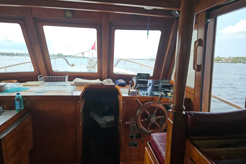 Slide: The Image of Interior view of 1977 Universal Marine Europa boat with wooden helm and navigation equipment. - 25
