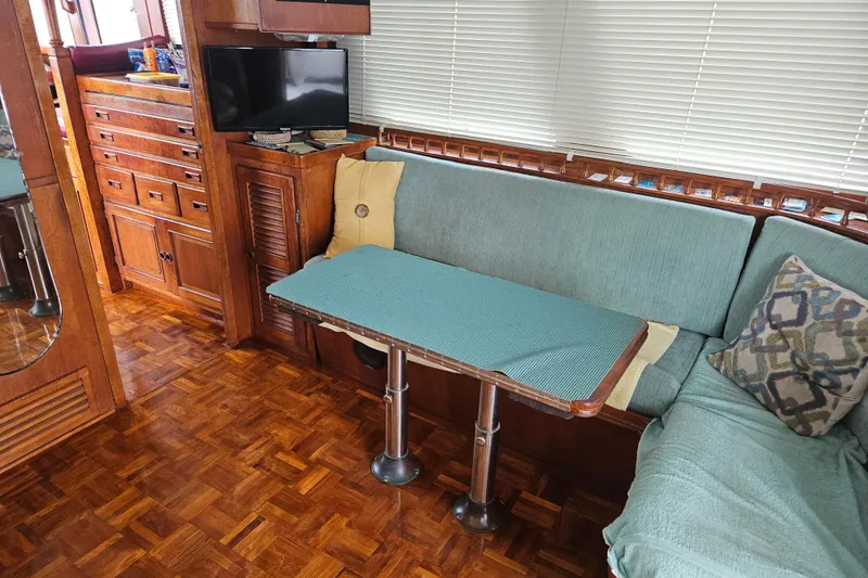 Slide: The Image of Interior of a 1977 Universal Marine Europa boat with wood finish and cozy seating area. - 31