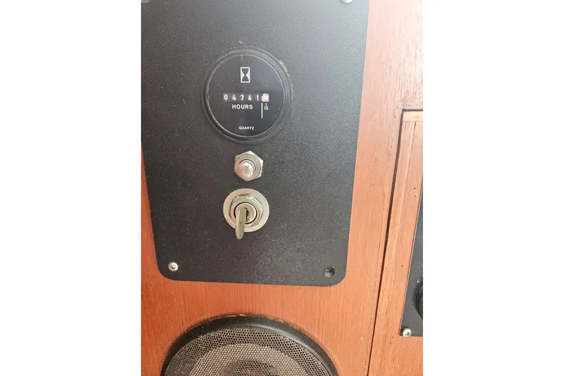 Slide: The Image of Control panel of a 1977 Universal Marine Europa boat with hour meter and ignition key. - 34