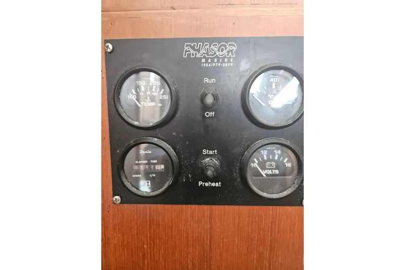 Slide: The Image of Control panel of a 1977 Universal Marine Europa boat with gauges and switches. - 35