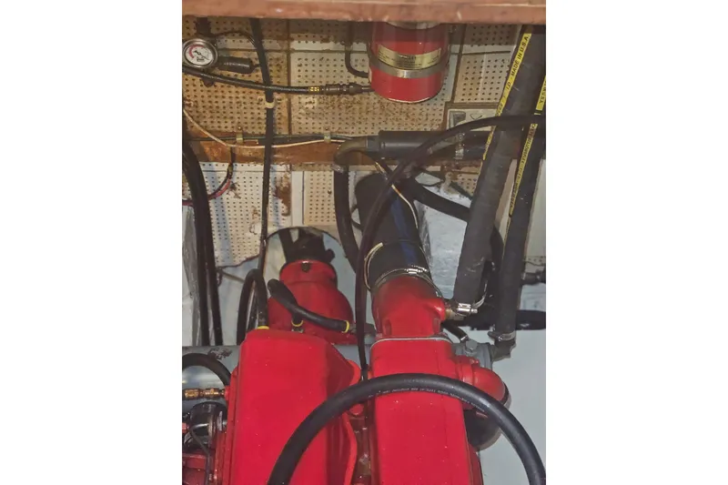 Slide: The Image of A red engine in a boat's engine room with hoses and cables. - 40