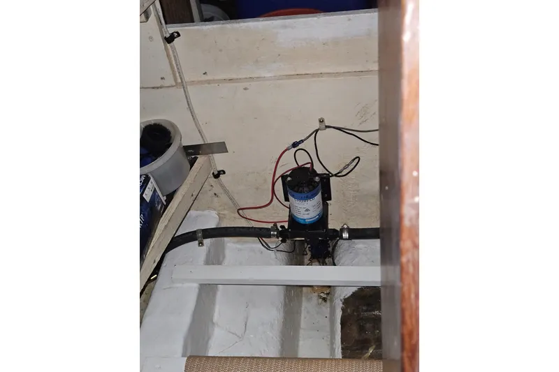 Slide: The Image of 1977 Universal Marine Europa boat interior with wiring and pump system. - 43