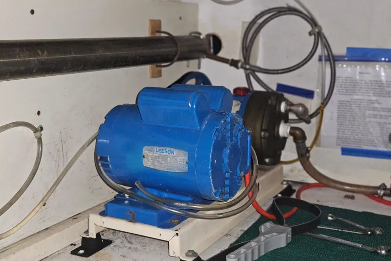 Slide: The Image of Blue Leeson motor in a 1977 Universal Marine Europa engine room with tools and pipes. - 44