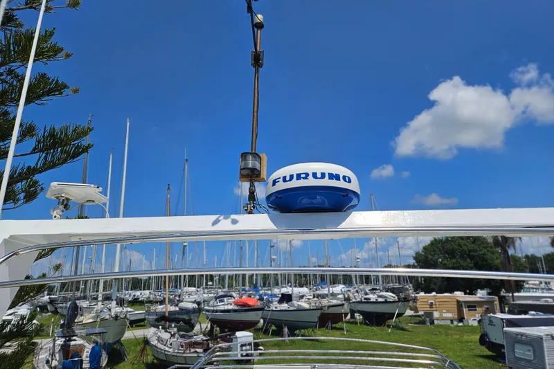 Slide: The Image of 1977 Universal Marine Europa boat with Furuno radar, docked in a marina under a clear blue sky. - 47