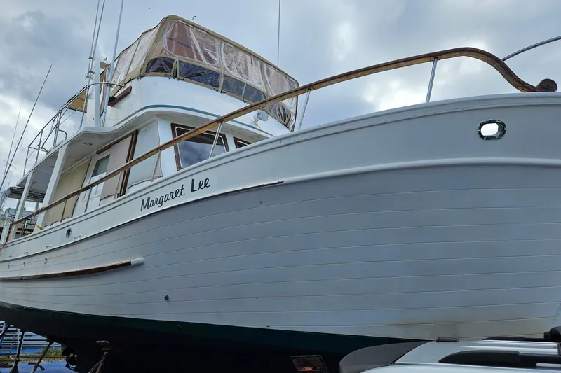 Slide: The Image of 1977 Universal Marine Europa boat "Margaret Lee" docked under cloudy sky. - 7