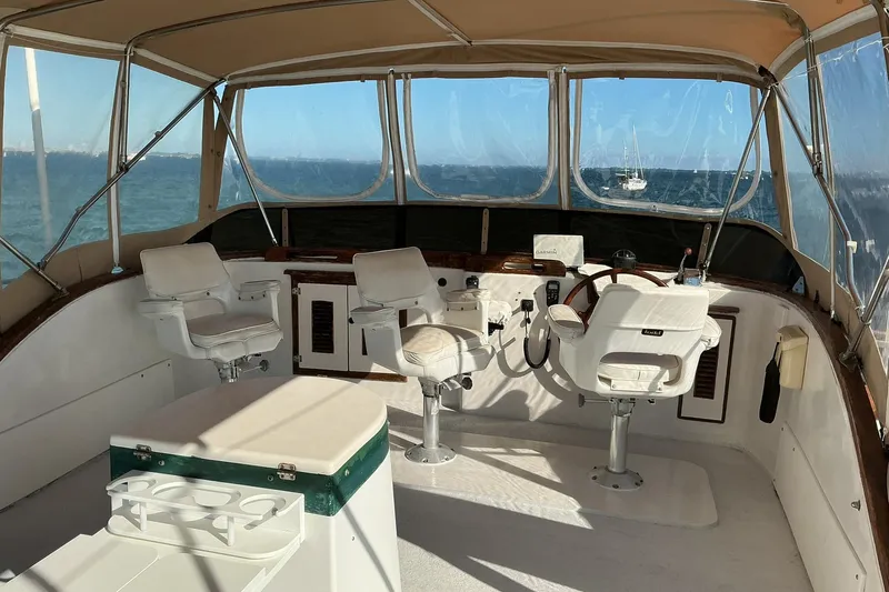 Slide: The Image of 1977 Universal Marine Europa boat cockpit with white seating and ocean view. - 8