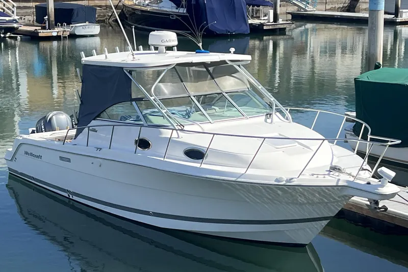The Image of 2006 Wellcraft 290 Coastal boat docked in a marina, featuring sleek design and modern amenities. - 0