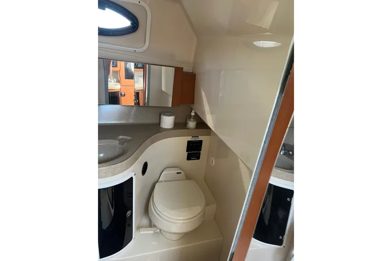 Slide: The Image of 2006 Wellcraft 290 Coastal boat bathroom with sink, toilet, and mirror. - 16