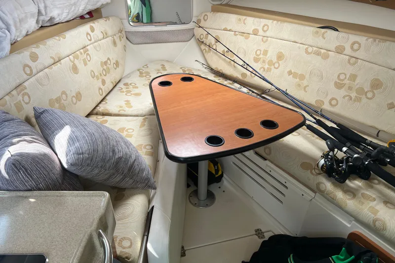 Slide: The Image of Interior of 2006 Wellcraft 290 Coastal boat with cushioned seating and fishing rods. - 17