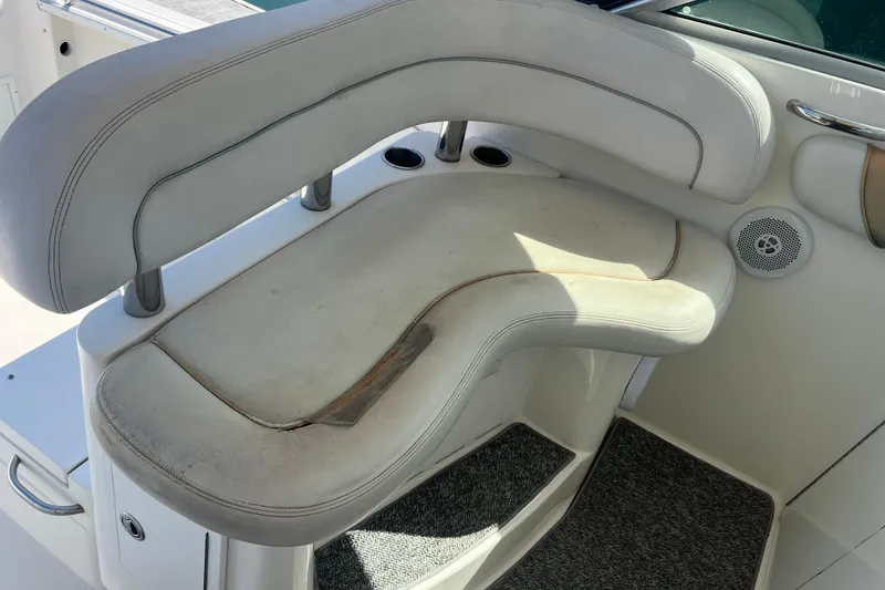 Slide: The Image of 2006 Wellcraft 290 Coastal boat seat with white upholstery and visible wear. - 22