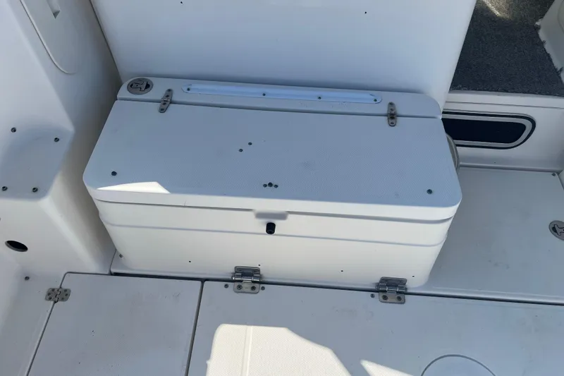 Slide: The Image of 2006 Wellcraft 290 Coastal boat storage compartment with white lid and hinges. - 25