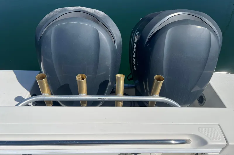 Slide: The Image of Twin Yamaha outboard engines on a 2006 Wellcraft 290 Coastal boat, docked on calm water. - 28