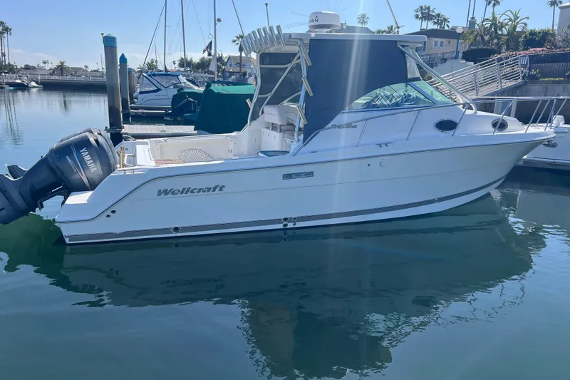 Slide: The Image of 2006 Wellcraft 290 Coastal boat docked in marina with Yamaha outboard motor. - 3