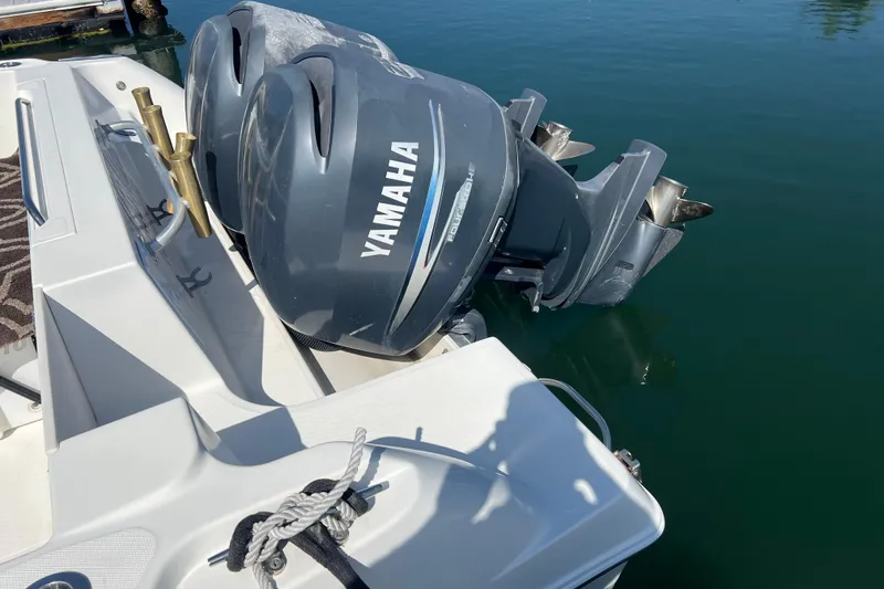 Slide: The Image of 2006 Wellcraft 290 Coastal boat with Yamaha outboard engines on calm water. - 32