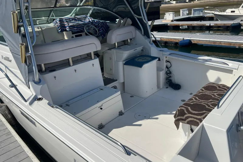 Slide: The Image of 2006 Wellcraft 290 Coastal boat interior with seating and dock view. - 33