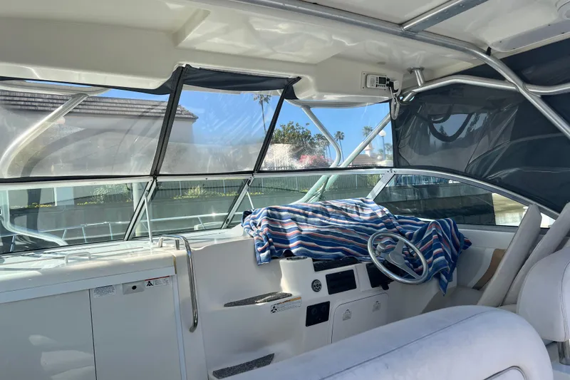 Slide: The Image of Interior of a 2006 Wellcraft 290 Coastal boat with steering wheel and striped cloth. - 35