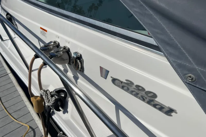 Slide: The Image of 2006 Wellcraft 290 Coastal boat side view with docked ropes and fittings. - 36