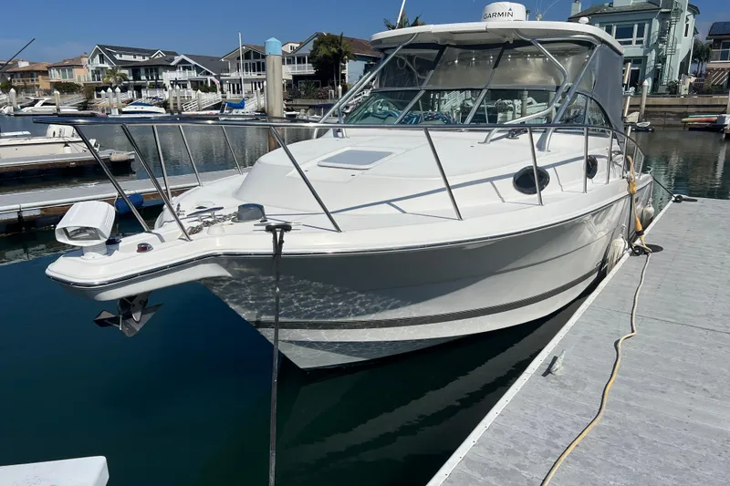 Slide: The Image of 2006 Wellcraft 290 Coastal boat docked at a marina, featuring sleek design and modern amenities. - 5