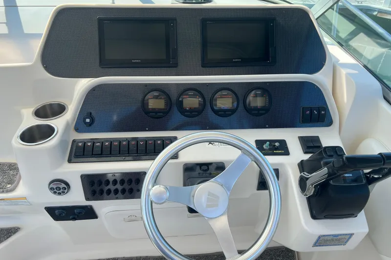 Slide: The Image of 2006 Wellcraft 290 Coastal helm with dual displays, gauges, and steering wheel. - 6