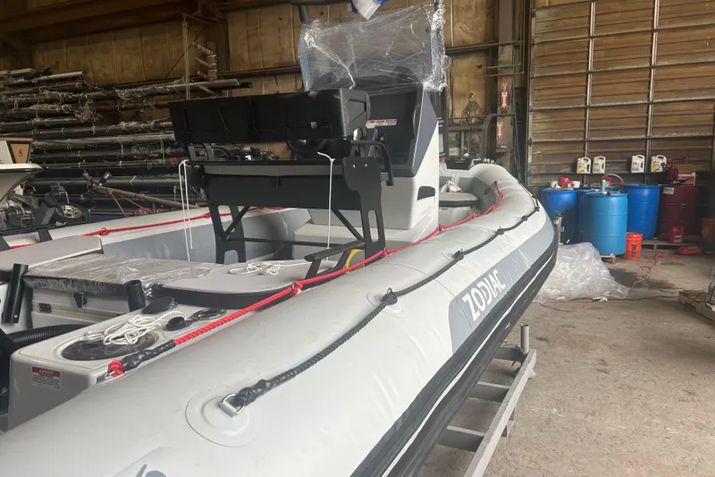Slide: The Image of 2025 Zodiac Open 6.5 boat in a warehouse, showcasing its sleek design and modern features. - 9