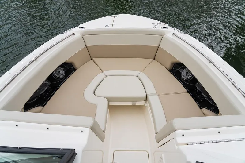 Slide: The Image of 2026 Boston Whaler 240 Vantage boat interior with beige seating and water view. - 15