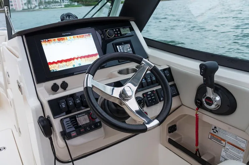 Slide: The Image of 2026 Boston Whaler 240 Vantage helm with advanced navigation and control systems. - 16