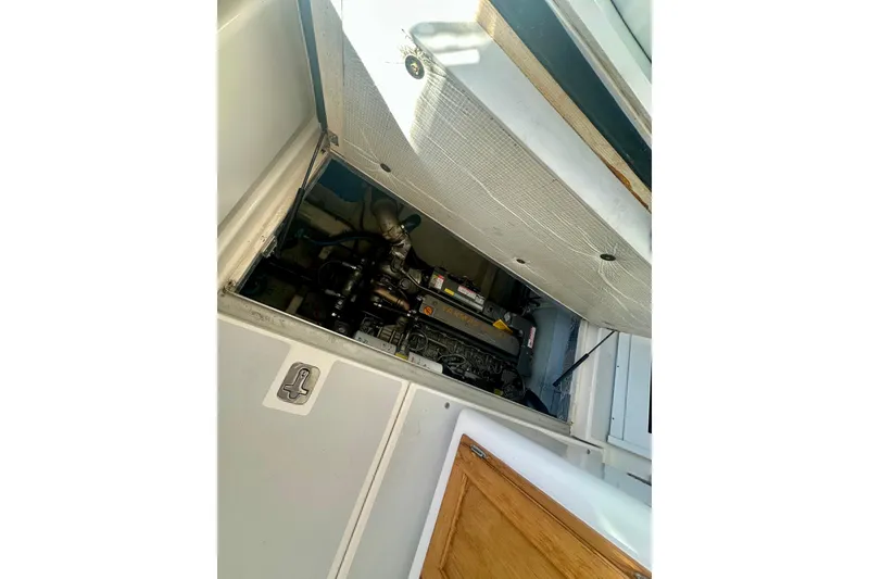 Slide: The Image of Engine compartment of 2005 Legacy Yachts 34 Express, showcasing mechanical components. - 14