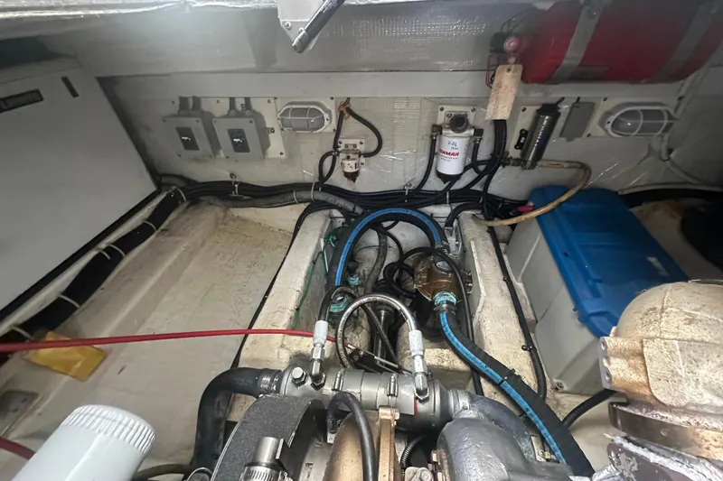 Slide: The Image of Engine room of 2005 Legacy Yachts 34 Express, showcasing mechanical components and wiring. - 17