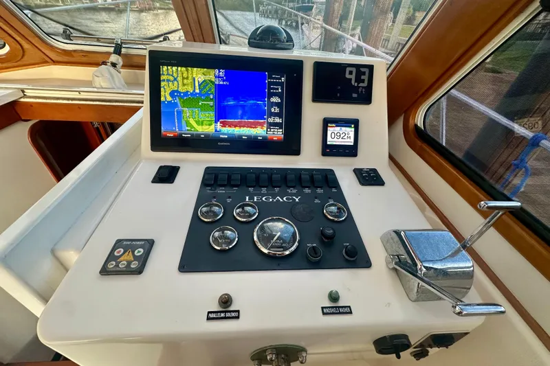 Slide: The Image of Helm of 2005 Legacy Yachts 34 Express with navigation and control instruments. - 6