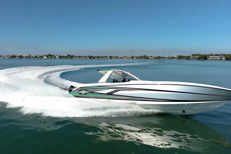 Slide: The Image of 2024 Cigarette 42' Auroris speedboat cruising on a clear blue lake. - 11