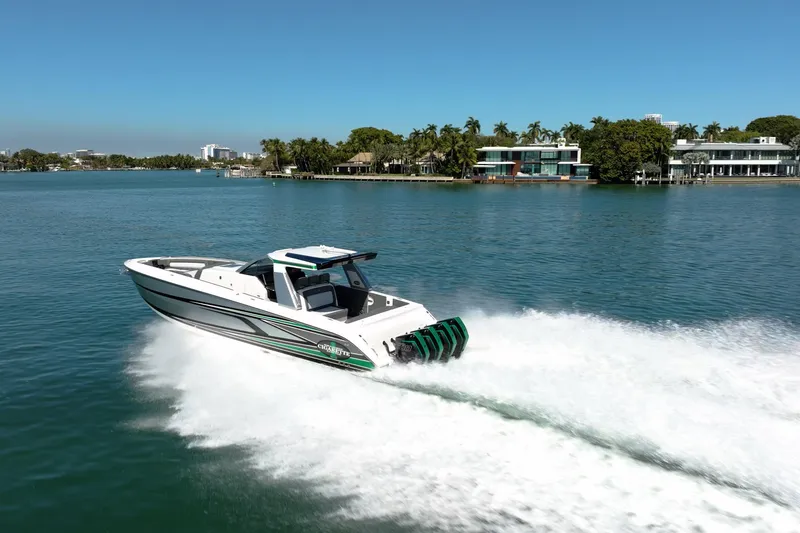 Slide: The Image of 2024 Cigarette 42' Auroris speedboat cruising on a sunny, scenic waterway. - 12