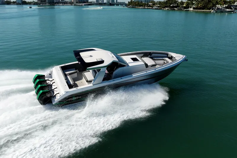 Slide: The Image of 2024 Cigarette 42' Auroris speedboat cruising on clear blue water. - 14