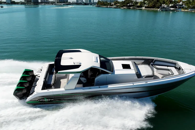 Slide: The Image of 2024 Cigarette 42' Auroris speedboat cruising on clear blue water. - 15